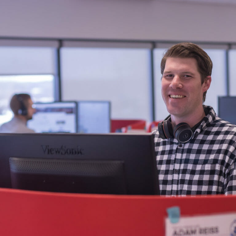 BDR employee at desk with headset