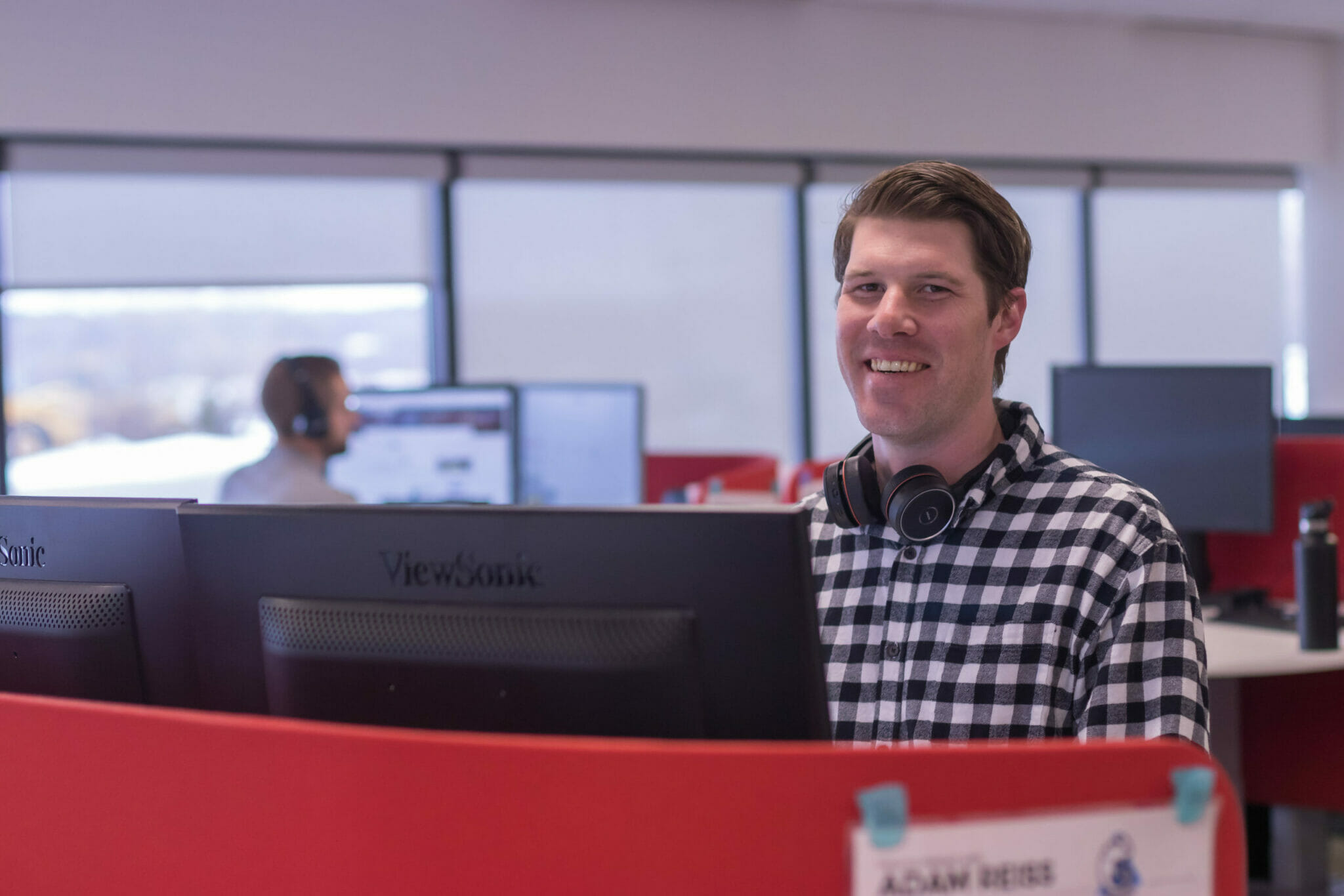 BDR employee at desk with headset