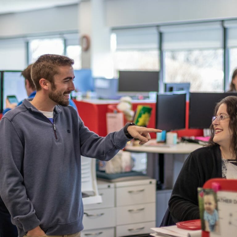 Two coworkers smiling