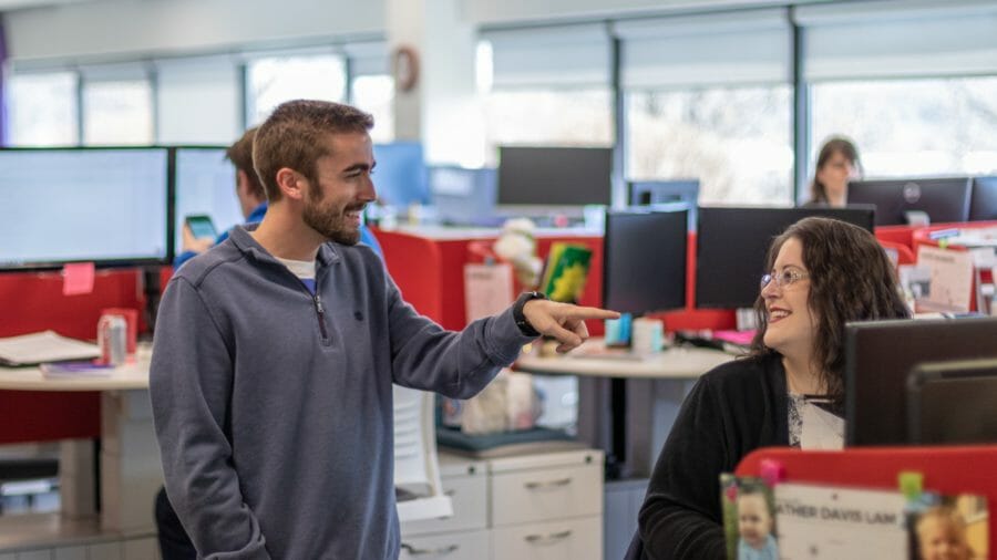 Two coworkers smiling