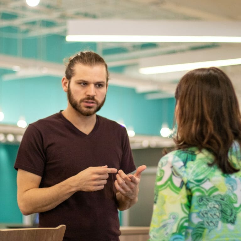 Two coworkers discussing