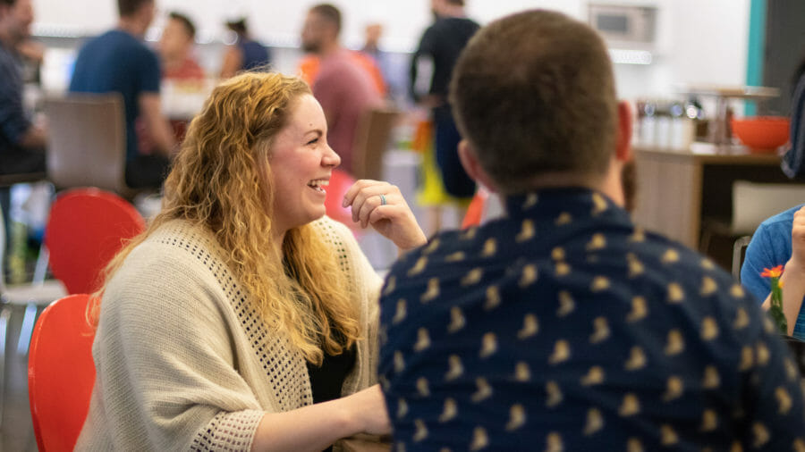 Two engaged employees laughing