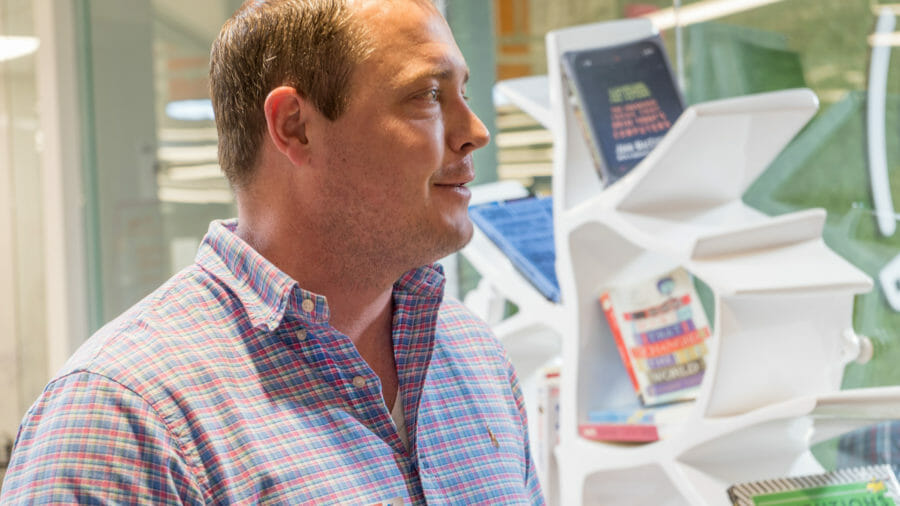 employee standing near book shelf