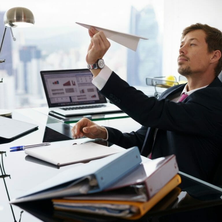 Employee throwing paper airplane