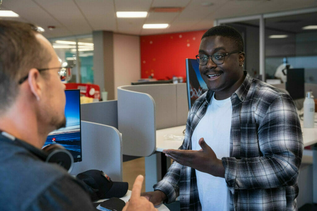 two engaged employees talking to each other