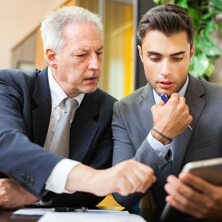 Men looking at info on tablet