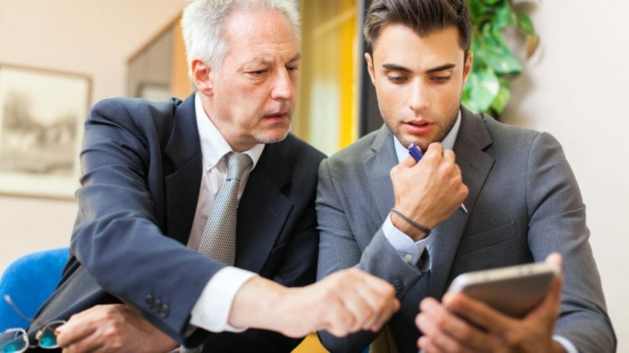 Men looking at info on tablet