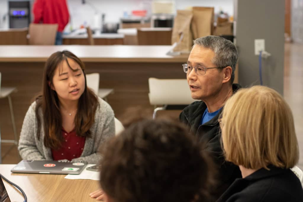 PI employees sitting in on a team meeting