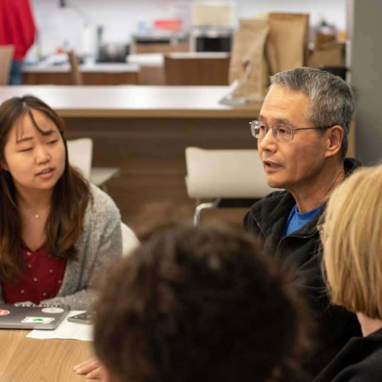 PI employees sitting in on a team meeting