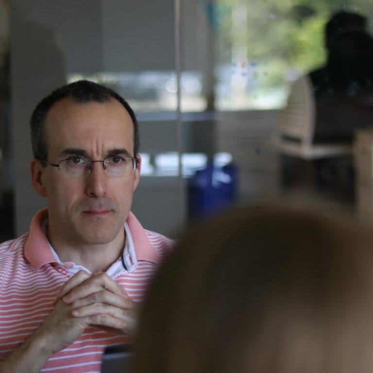 man listening in group