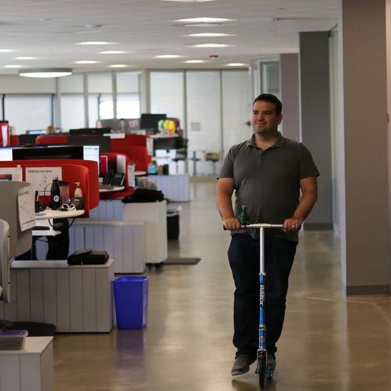 man on scooter in office